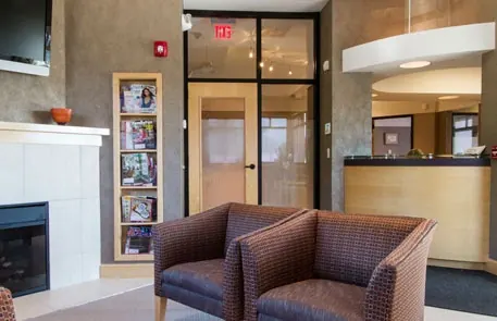 Inside the entrance: two armchairs by the fireplace, a magazine rack and the reception counter.