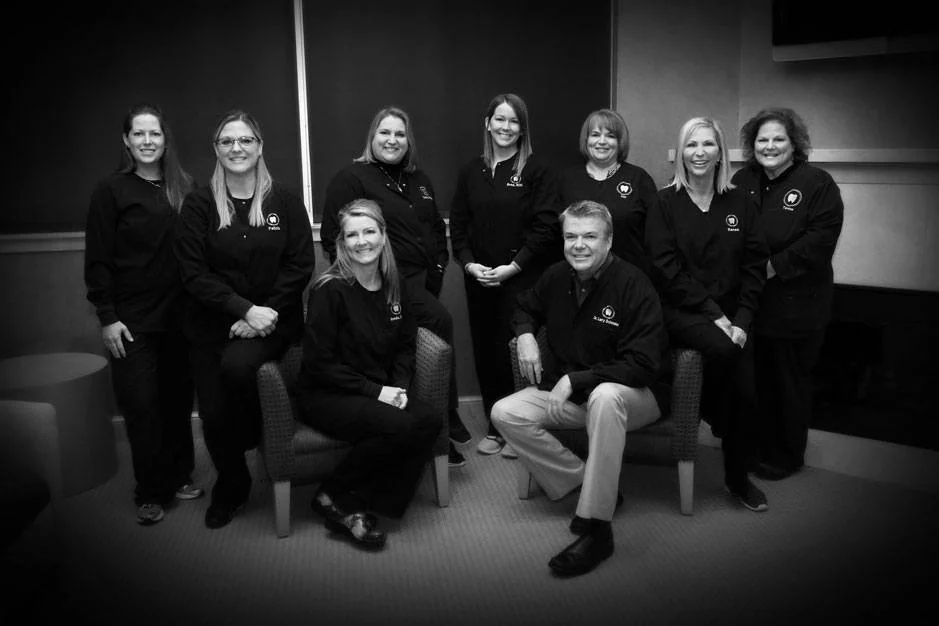 The Sylvania Smile Design team with Dr. Larry Schmakel, in black and white, in the waiting room.